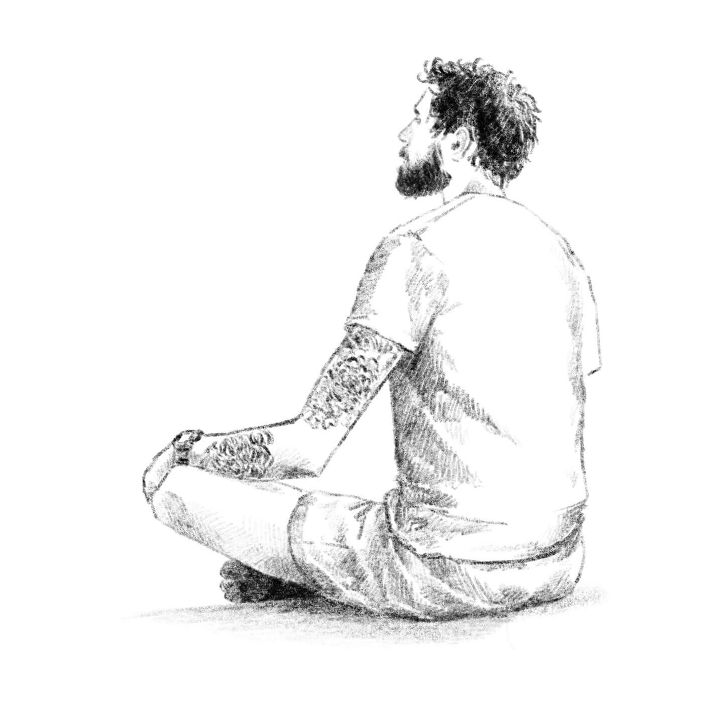 portrait of a tall, lanky man sitting cross legged from the back
